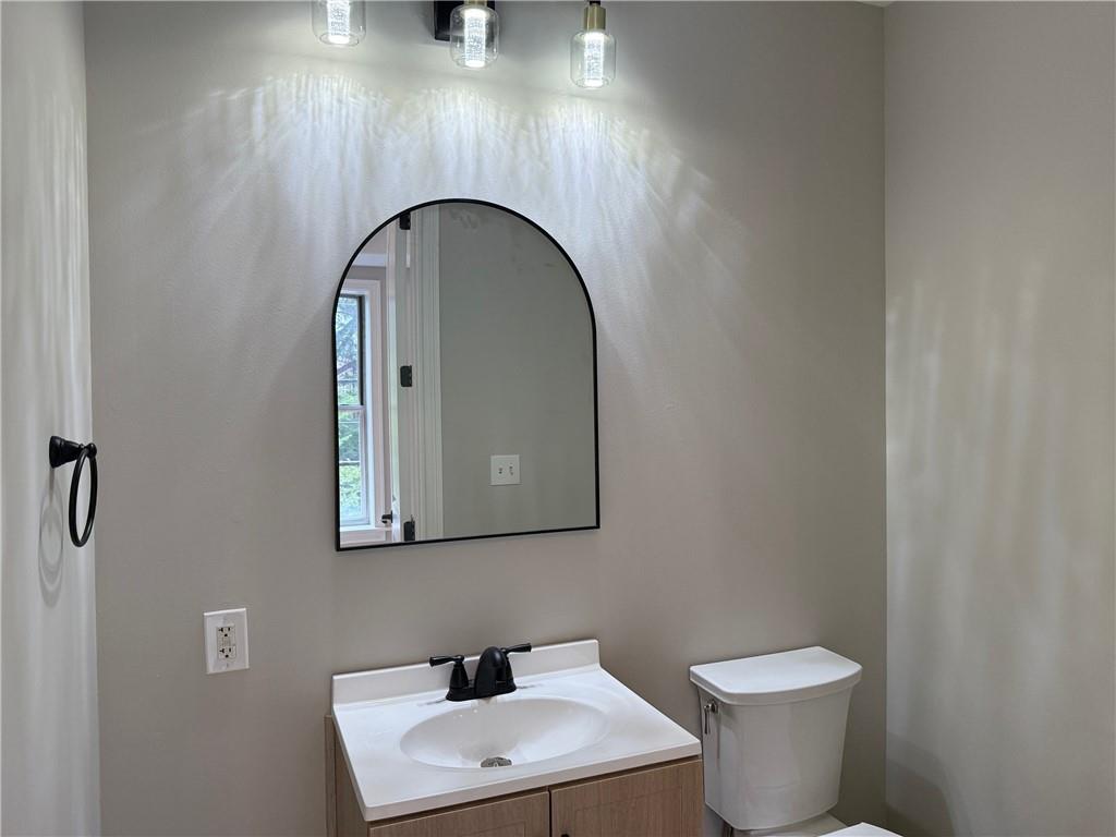 2255 Peachtree Road Northeast, Unit 322 Atlanta, GA 30309 - Photo 15 of 25 a bathroom with a toilet sink and mirror