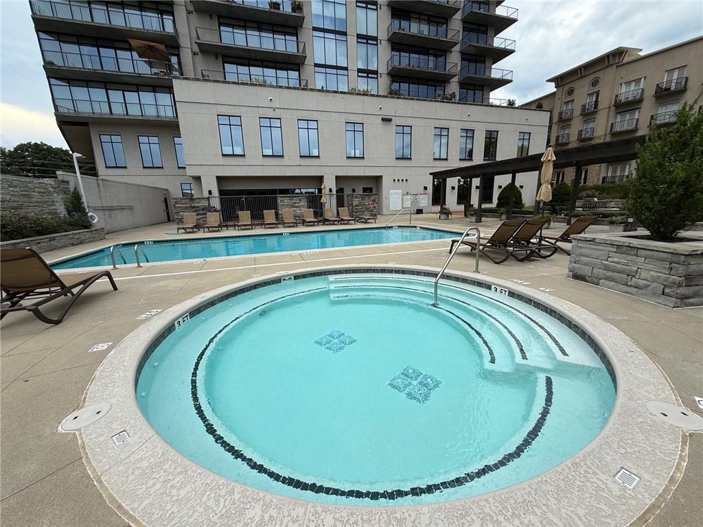 2255 Peachtree Road Northeast, Unit 322 Atlanta, GA 30309 - Photo 18 of 25 a view of a swimming pool with outdoor seating