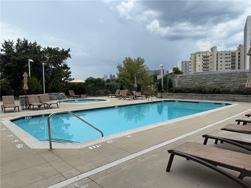 2255 Peachtree Road Northeast, Unit 322 Atlanta, GA 30309 - Photo 20 of 25 a view of swimming pool with outdoor seating and yard in back