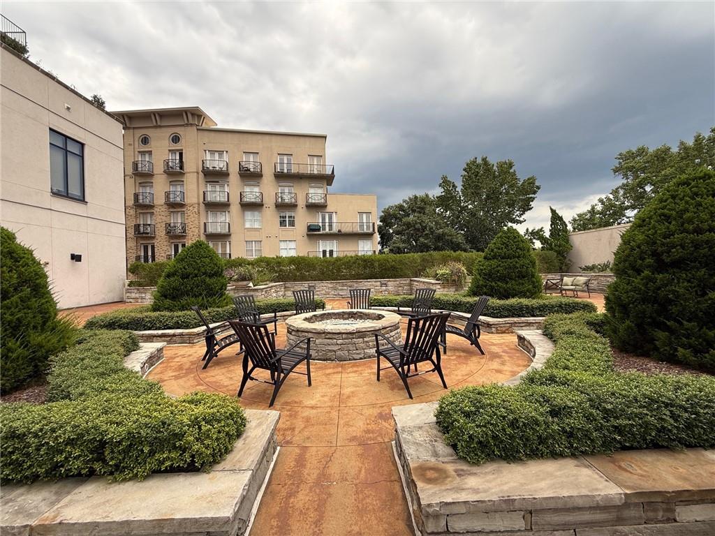 2255 Peachtree Road Northeast, Unit 322 Atlanta, GA 30309 - Photo 21 of 25 a view of a swimming pool with outdoor seating and plants
