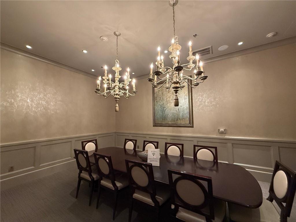 2255 Peachtree Road Northeast, Unit 322 Atlanta, GA 30309 - Photo 25 of 25 a view of a dining room with furniture and chandelier
