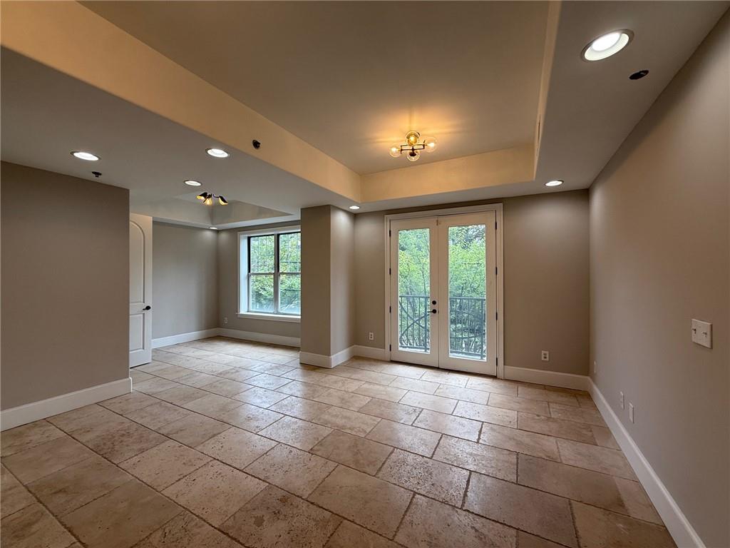 2255 Peachtree Road Northeast, Unit 322 Atlanta, GA 30309 - Photo 4 of 25 a view of an empty room with windows and chandelier