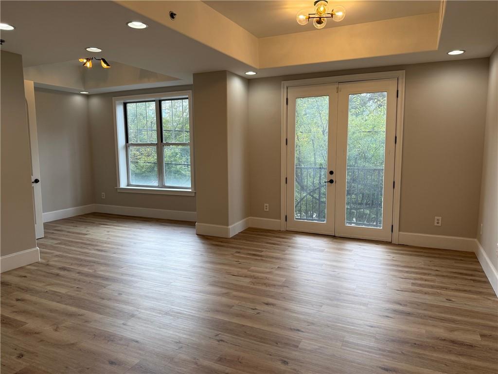 2255 Peachtree Road Northeast, Unit 322 Atlanta, GA 30309 - Photo 5 of 25 an empty room with wooden floor and windows