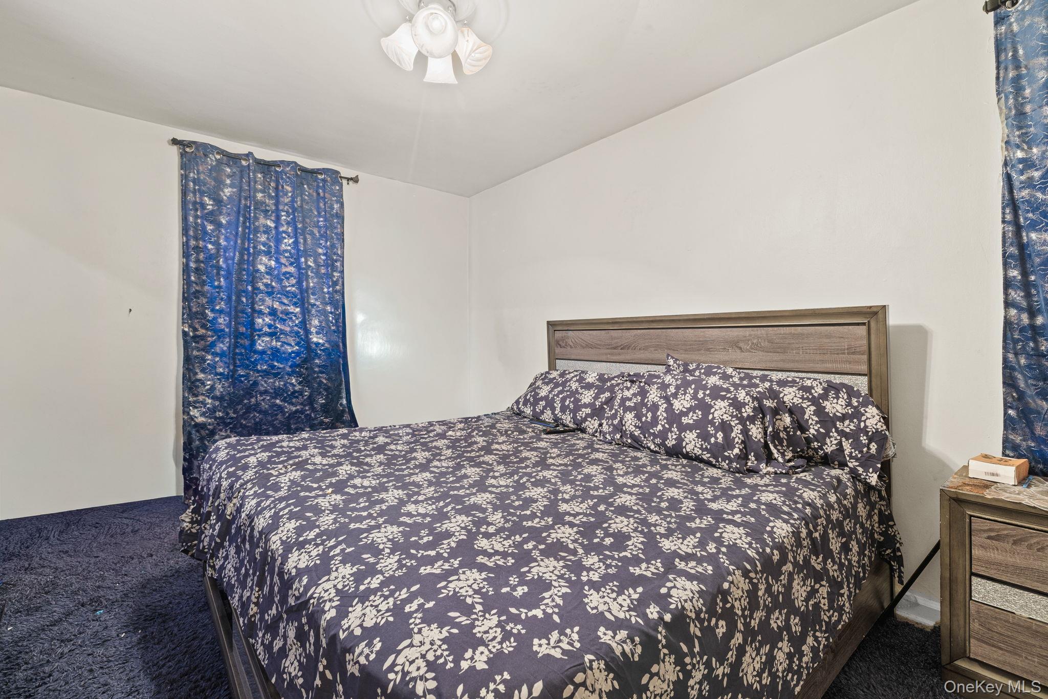 2105 Wallace Avenue, Unit 5A Bronx, NY 10462 - Photo 11 of 15 a large bed sitting in a bedroom next to a bed and a chandelier