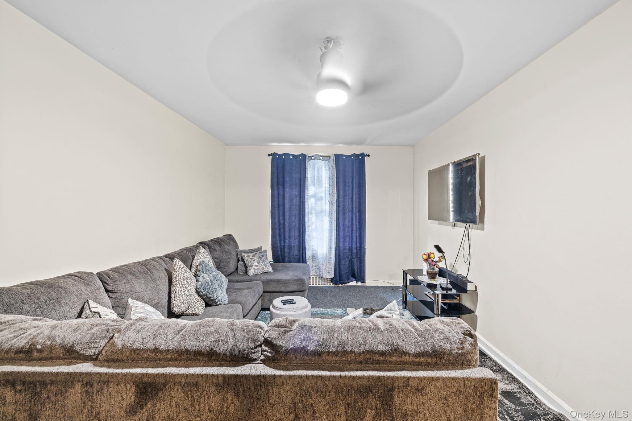 2105 Wallace Avenue, Unit 5A Bronx, NY 10462 - Photo 13 of 15 a living room with furniture and a flat screen tv