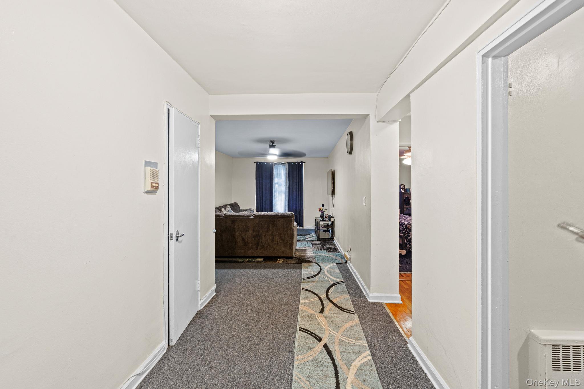 2105 Wallace Avenue, Unit 5A Bronx, NY 10462 - Photo 14 of 15 a view of a hallway with a livingroom and furniture