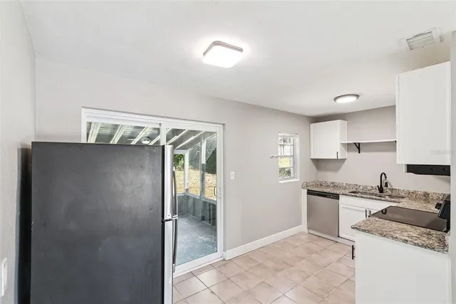 a kitchen with stainless steel appliances granite countertop a refrigerator and a sink