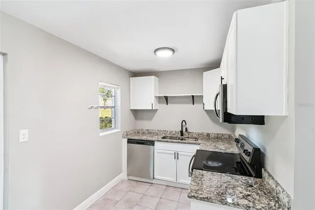 a kitchen with a sink and a stove top oven