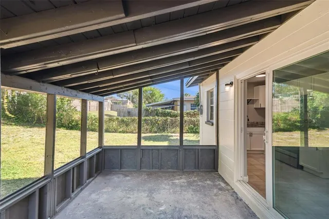 a view of an empty room with a large window