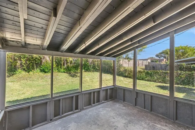 a view of an empty room with a large window