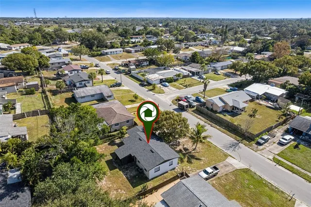 an aerial view of a residential houses with city view