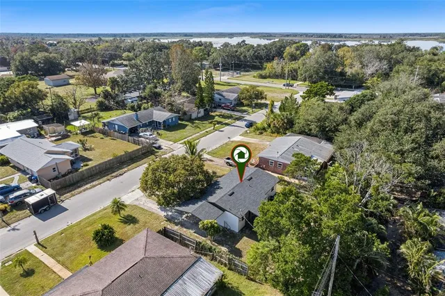 an aerial view of a house with a yard