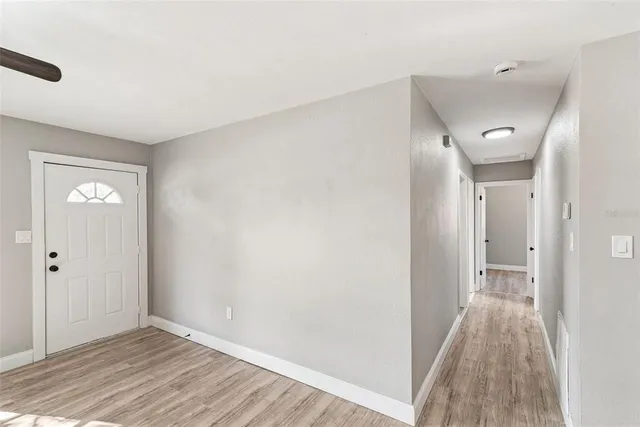a view of a hallway with wooden floor