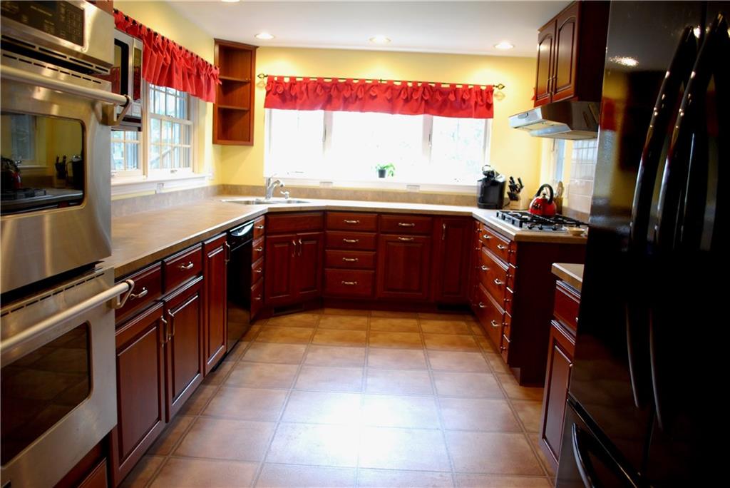 Sunny kitchen overlooking expansive back yard.  Gas cooktop, double stainless sink, and double oven.