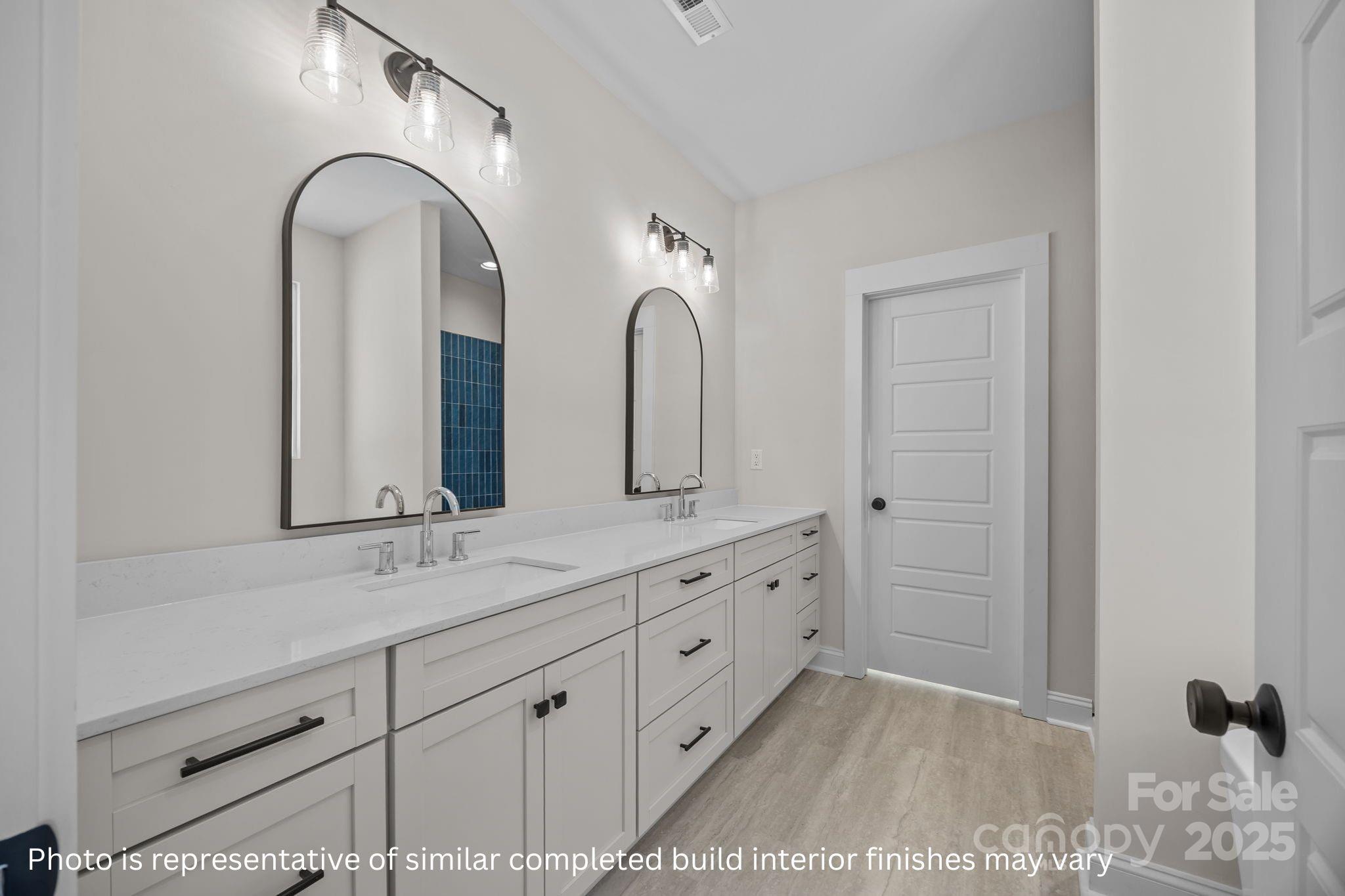 2279 Lee Lawing Road Lincolnton, NC 28092 - Photo 7 of 11 a bathroom with a double vanity sink and mirror