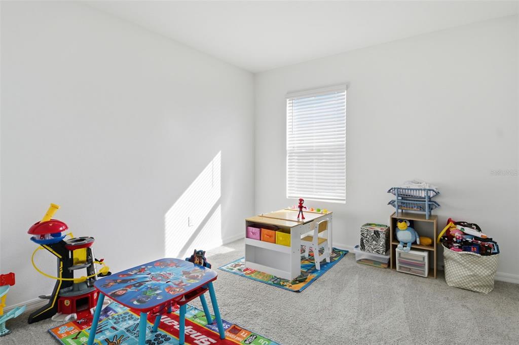 3844 Sunny Spring Street Plant City, FL 33565 - Photo 14 of 26 a living room with baby crib furniture and a window