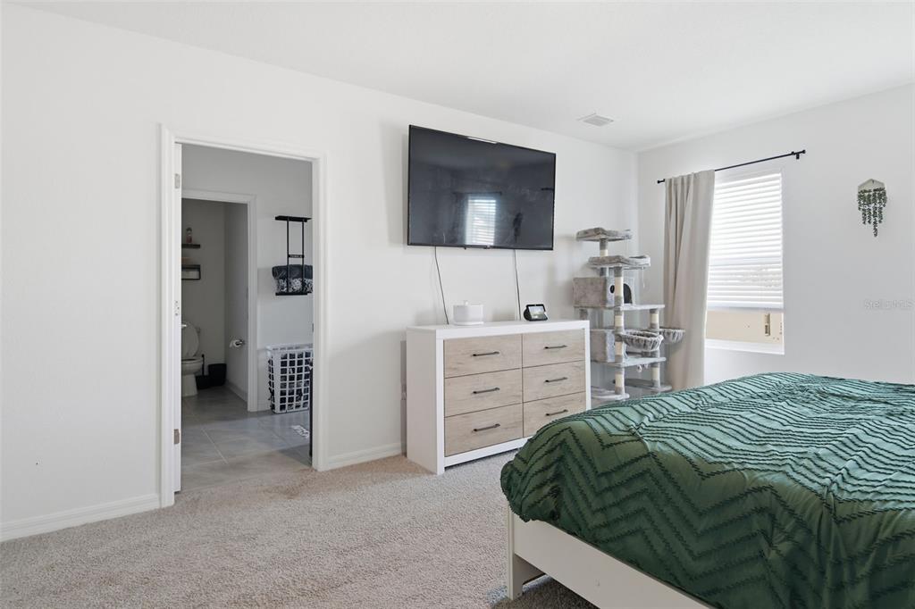 3844 Sunny Spring Street Plant City, FL 33565 - Photo 4 of 26 a bedroom with a bed and a room