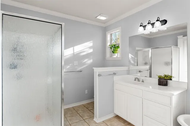 a bathroom with a sink double vanity mirror and shower