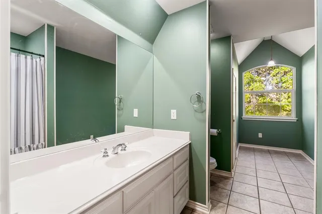 a en suite bathroom with a sink a mirror and a shower