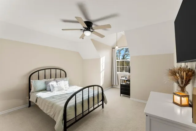 a living room with a bed furniture and a flat screen tv