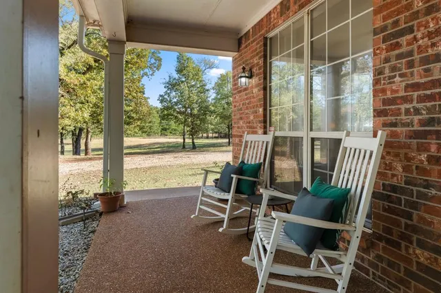 a view of a balcony with chair and table in the patio