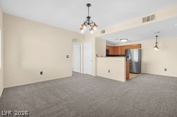 7701 West Robindale Road, Unit 277 Las Vegas, NV 89113 - Photo 6 of 33 An open-concept layout connects the living area to a compact, functional kitchen.
