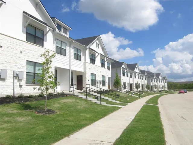 a front view of a building with a yard