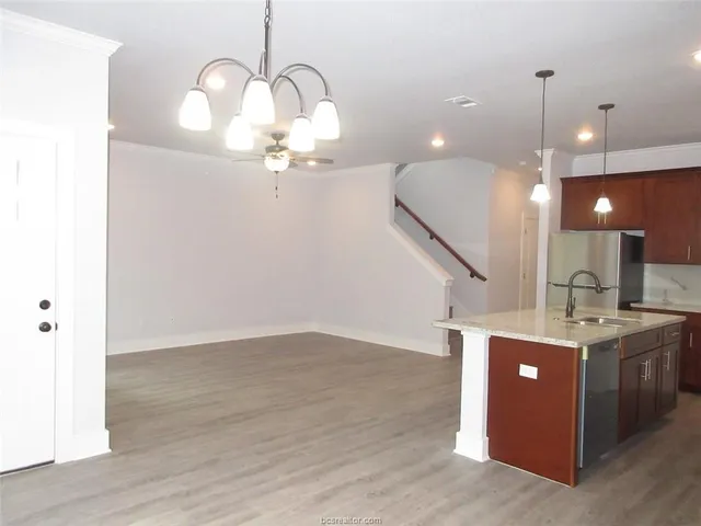 a view of a room with wooden floor and staircase