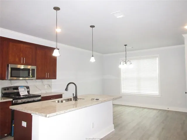 a kitchen with a sink a counter and appliances