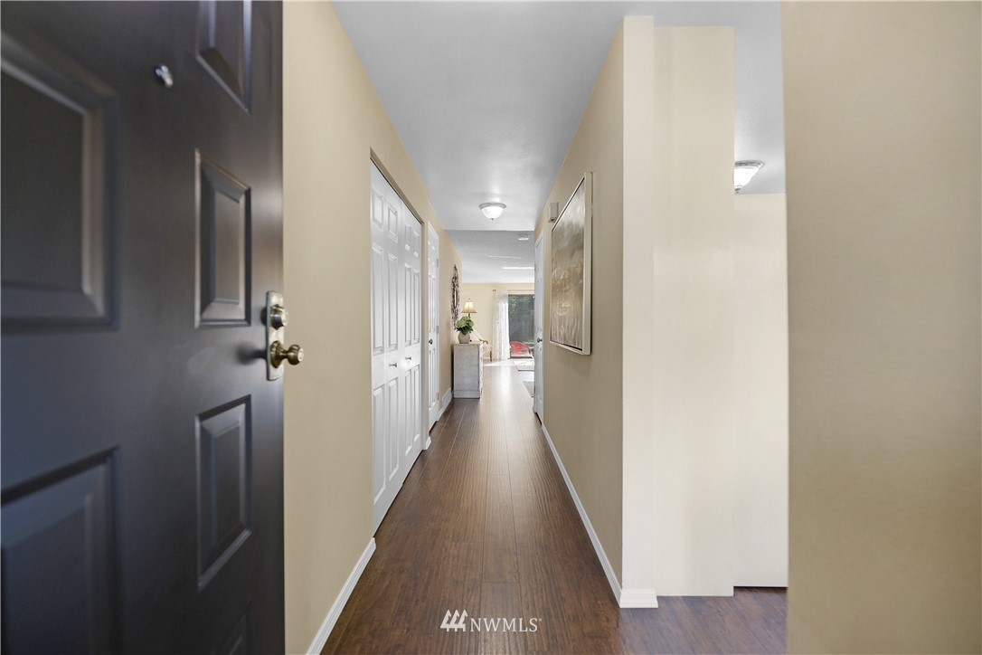 21529 4th Avenue West, Unit C33 Bothell, WA 98021 - Photo 3 of 35 a view of a hallway with wooden floor and staircase
