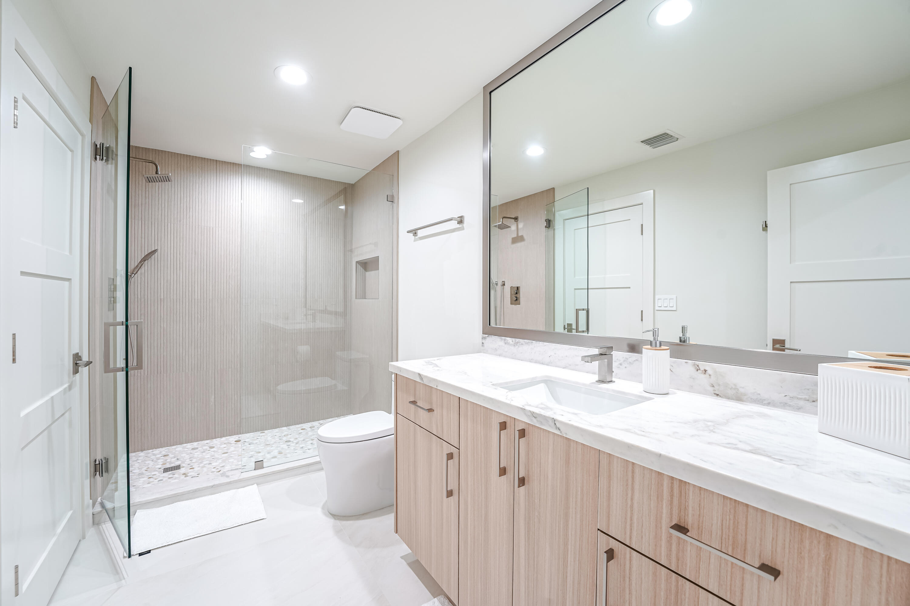 749 Northeast 71st Street Boca Raton, FL 33487 - Photo 29 of 43 a bathroom with a double vanity sink toilet and shower