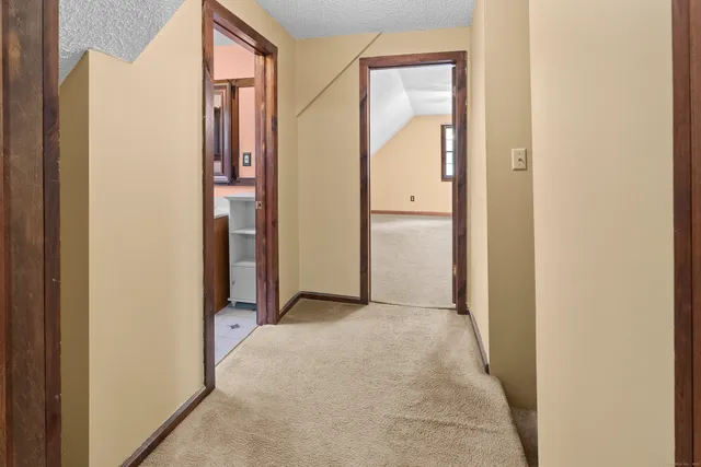 a view of a hallway with closet and wooden floor