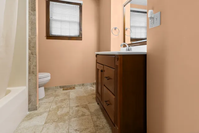 a bathroom with a sink a toilet and a mirror