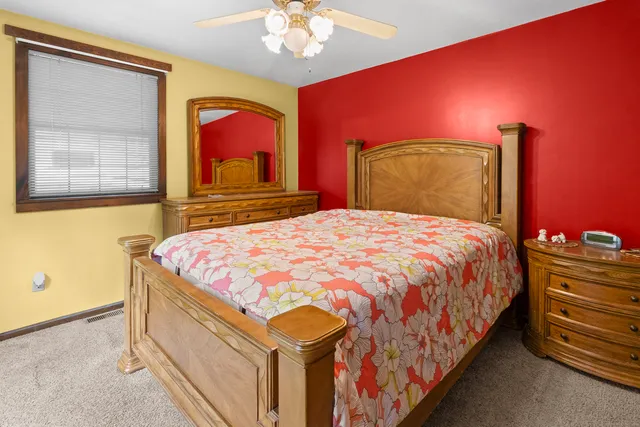 a bedroom with a bed and a mirror