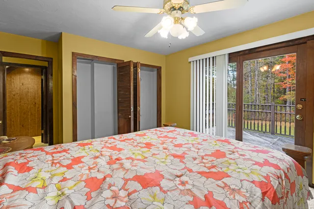 a bedroom with a large bed and a chandelier