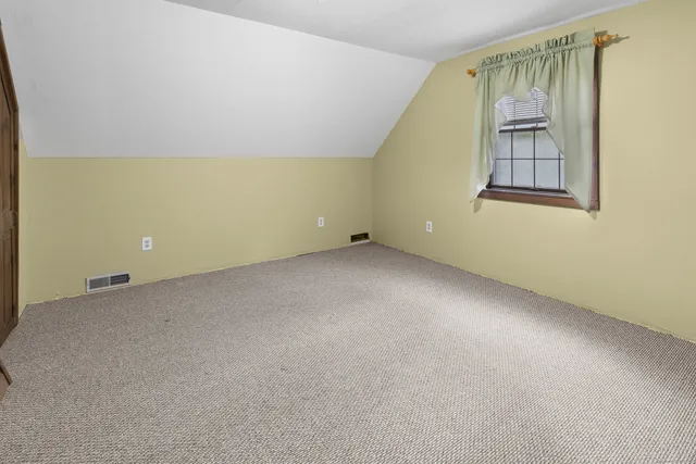 an empty room with windows and painted walls