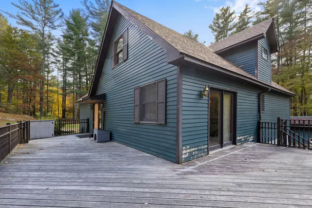 a view of a house with a backyard and trees