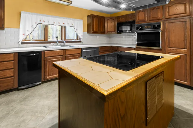 a kitchen with stainless steel appliances a stove a sink and a microwave