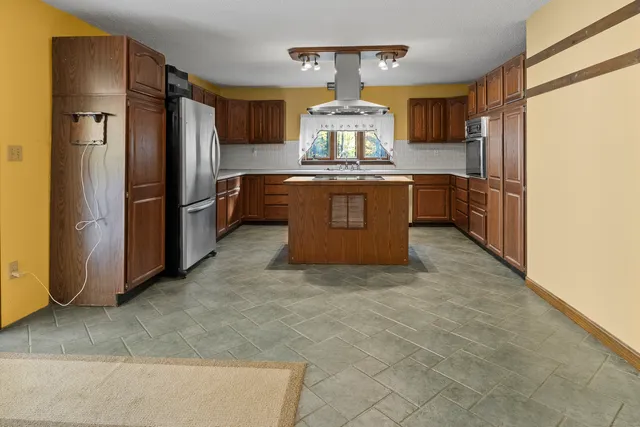 a kitchen with stainless steel appliances a refrigerator and a stove