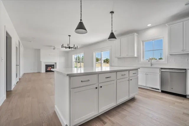 a kitchen with kitchen island white cabinets and white appliances