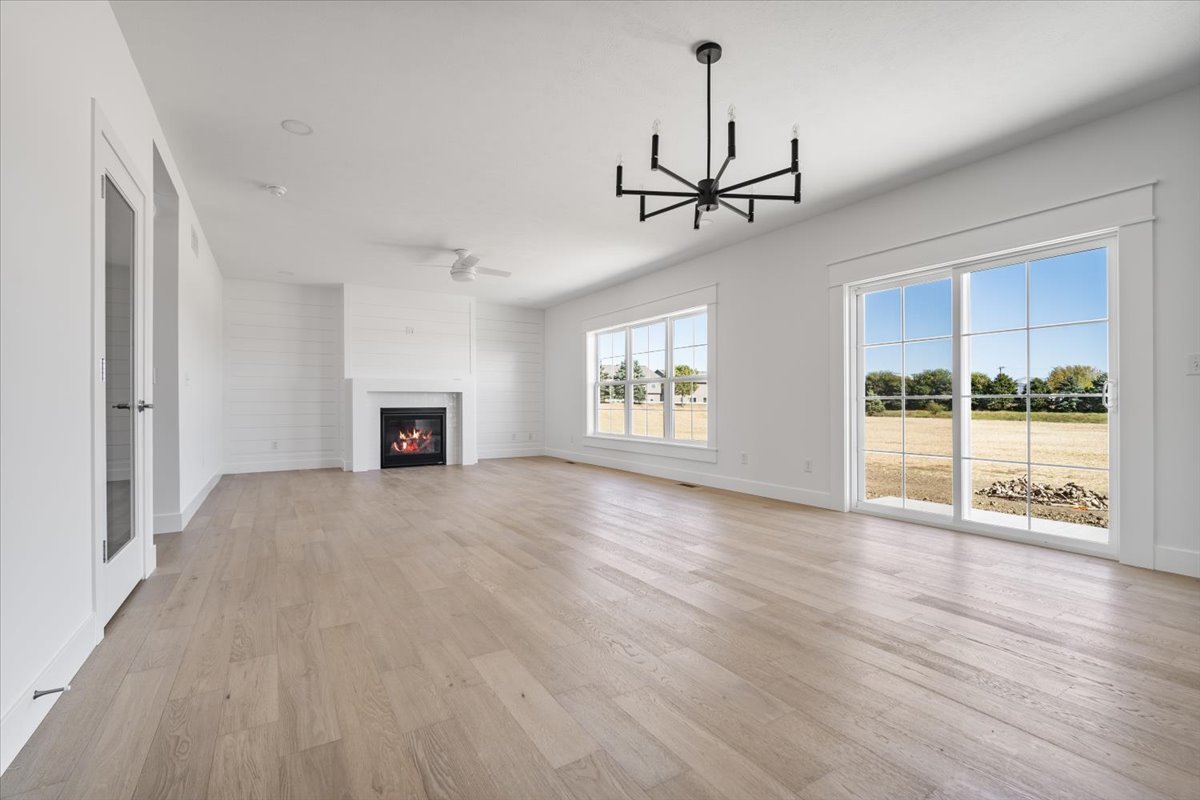 24 Stonehouse Court Bloomington, IL 61705 - Photo 14 of 45 a view of an empty room with a window and wooden floor