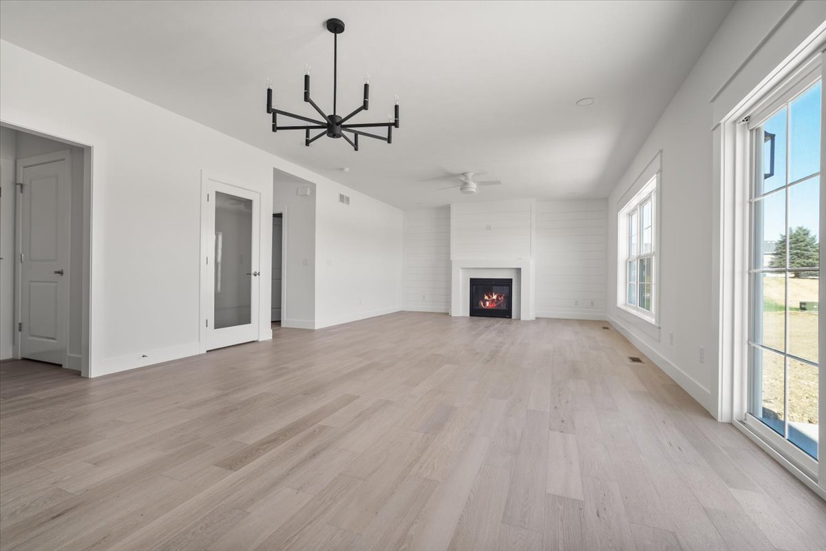 24 Stonehouse Court Bloomington, IL 61705 - Photo 15 of 45 a view of a livingroom with a ceiling fan window and hardwood floor