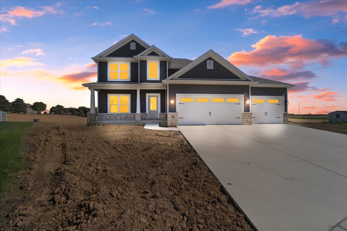 24 Stonehouse Court Bloomington, IL 61705 - Photo 2 of 45 a front view of a house with a yard and garage