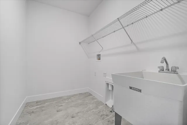 a view of a sink and dishwasher with cabinets