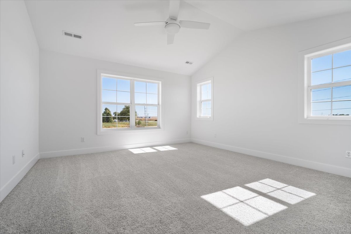 24 Stonehouse Court Bloomington, IL 61705 - Photo 24 of 45 an empty room with windows and chandelier fan