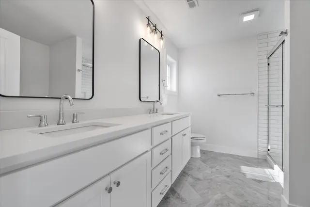 a bathroom with a double vanity sink and a mirror