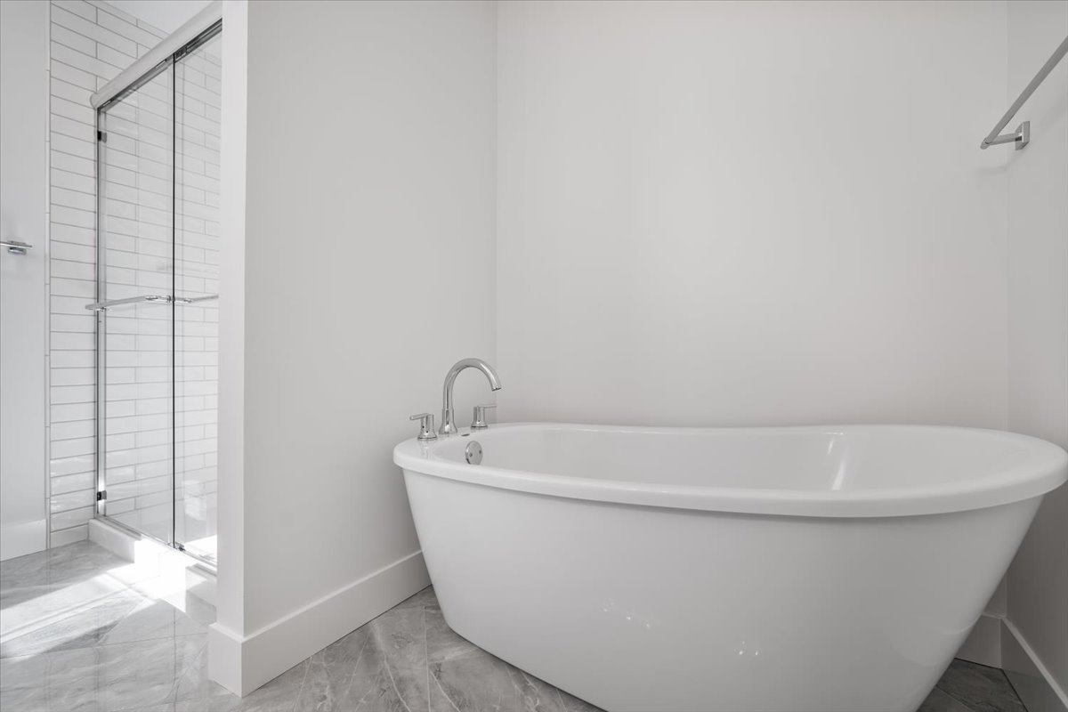 24 Stonehouse Court Bloomington, IL 61705 - Photo 27 of 45 a white bath tub sitting in a bathroom