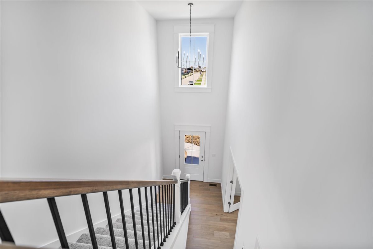 24 Stonehouse Court Bloomington, IL 61705 - Photo 33 of 45 a view of a hallway with wooden floor and windows
