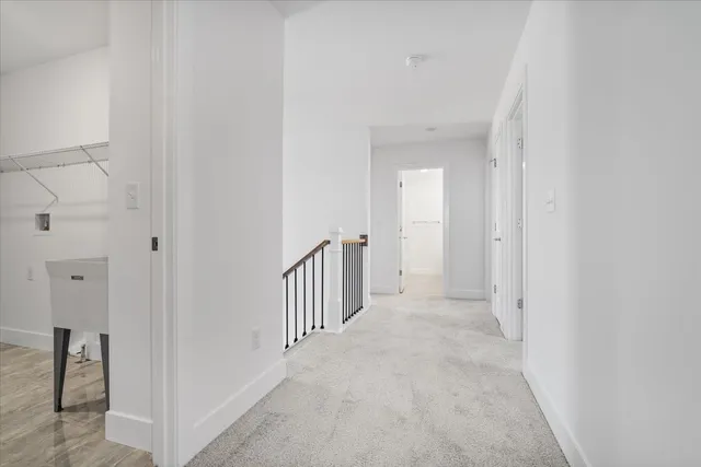 a view of a hallway with closet and door