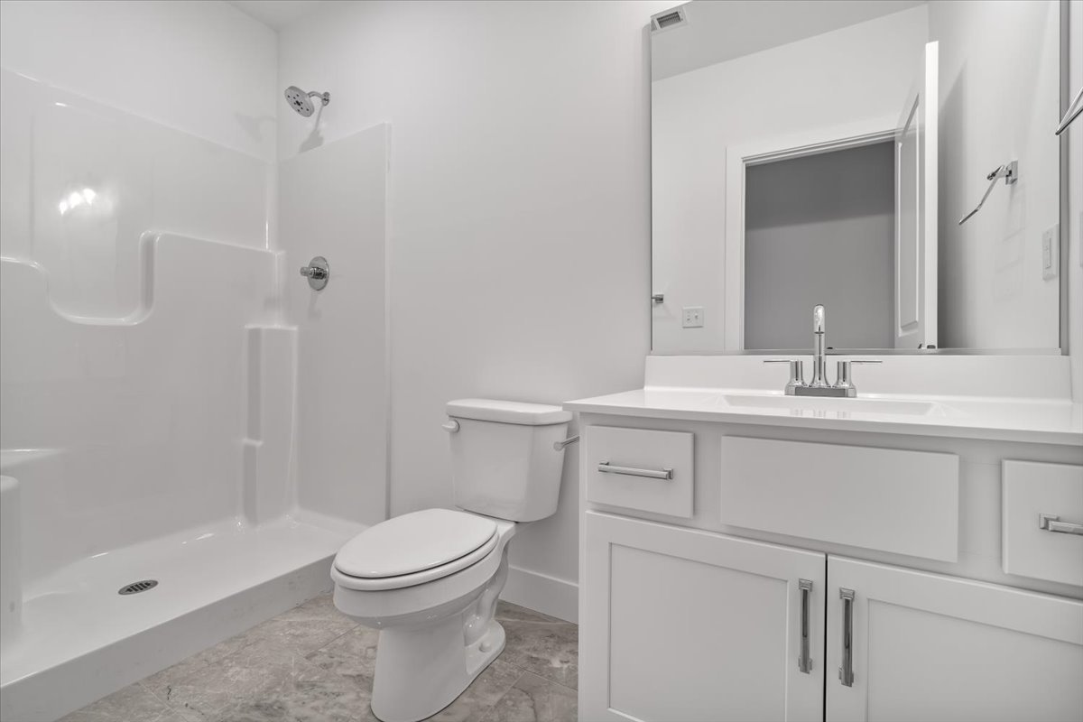 24 Stonehouse Court Bloomington, IL 61705 - Photo 39 of 45 a bathroom with a sink a toilet and shower